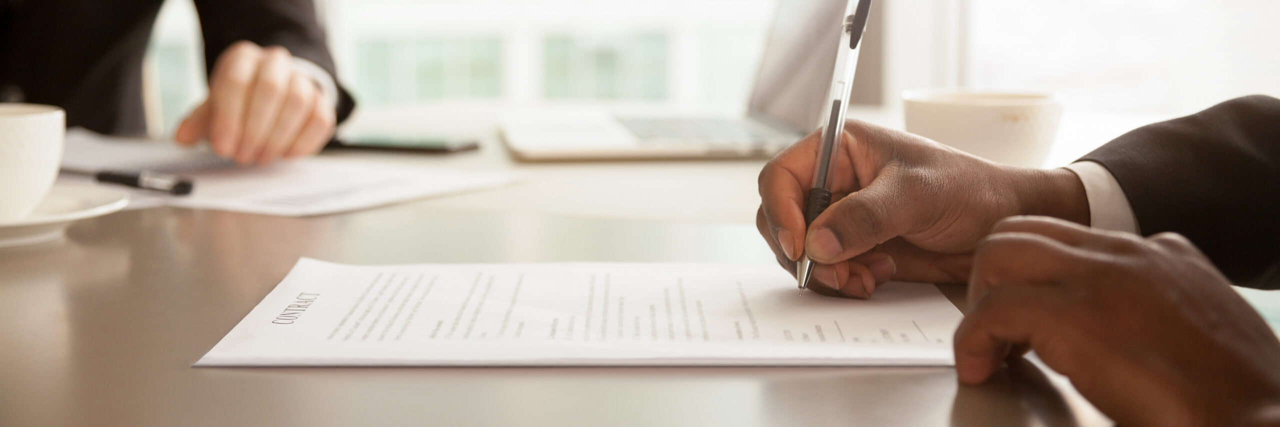 business man sitting down and filling out business documents
