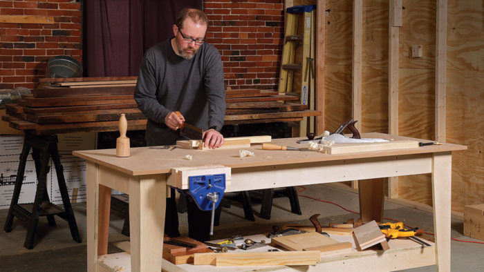 man working on cabinets