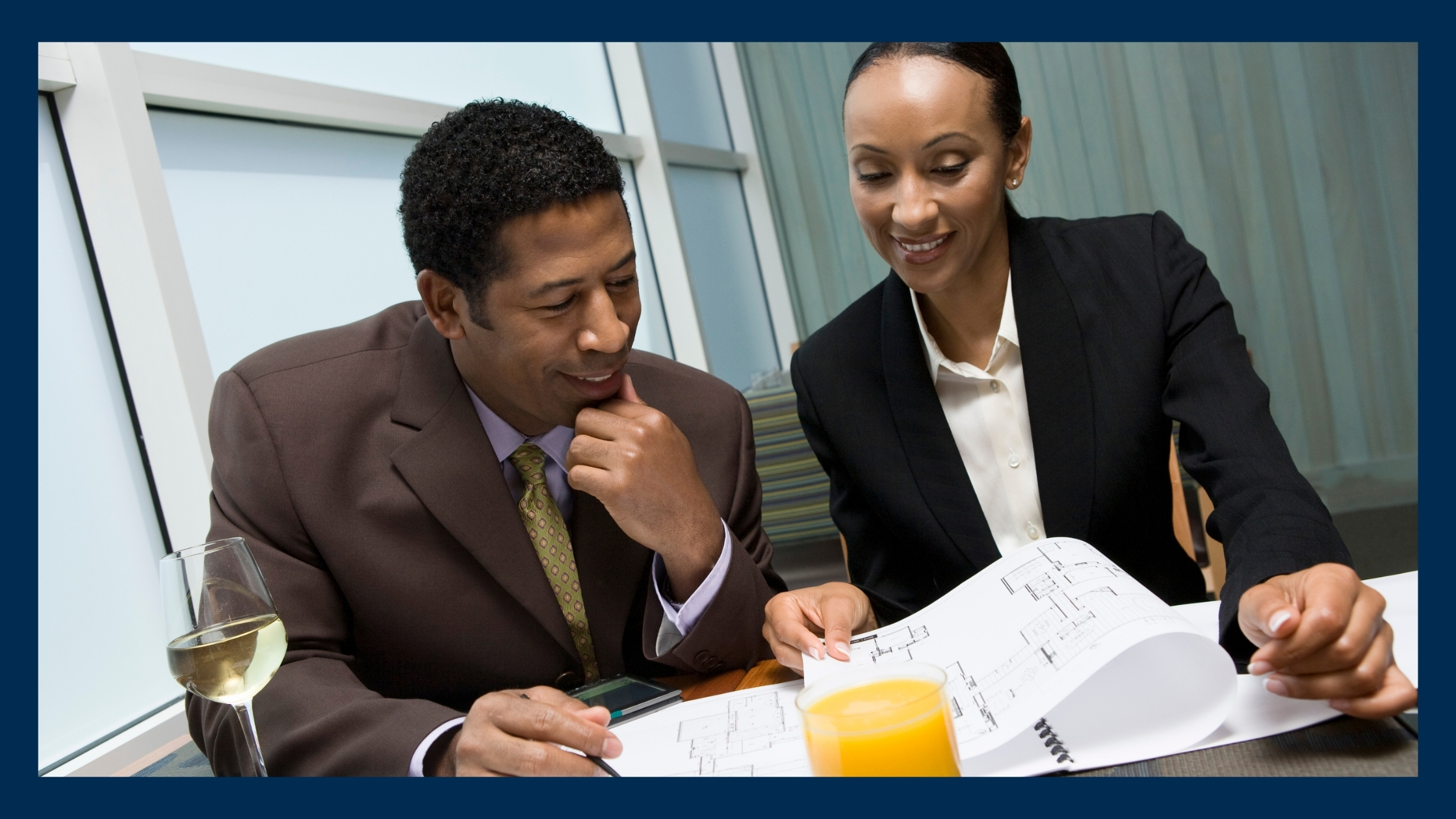 A man and a woman discussing a business deal